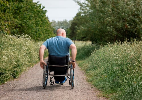 A man in a wheelchair enjoying time outdoors | Mobility Blog