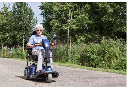 A senior using an electric mobility scooter outdoors | Modern Mobility Solutions