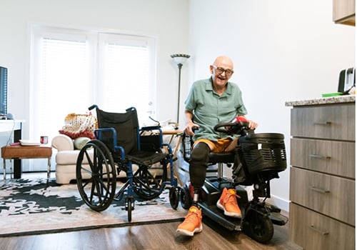 An older adult sitting on a mobility scooter | Modern Mobility Solutions