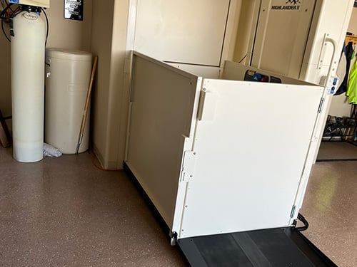 Vertical platform lift (VPL) within a residential garage | Mobility Equipment Supplier